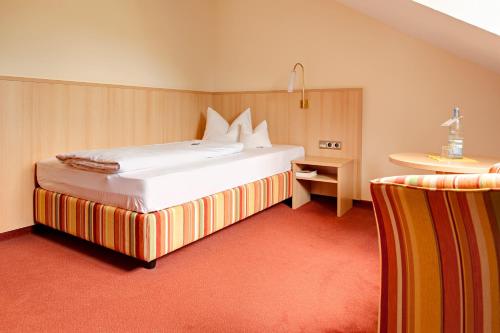 a bedroom with a large white bed in a room at BSW Hotel Isarwinkel in Bad Tölz