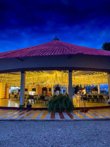 a pavilion with tables and chairs at night at Hotel y Parque Turístico Navar City in Villavicencio