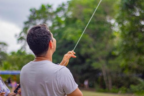 a man is holding onto a kite at Hotel y Parque Turístico Navar City in Villavicencio