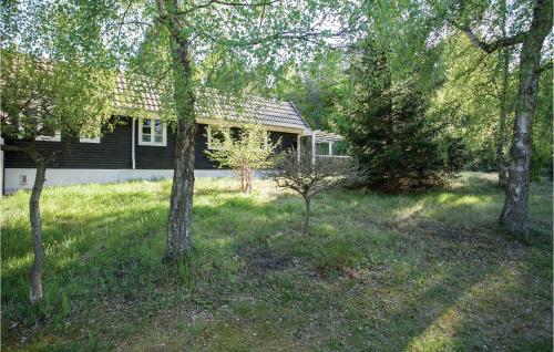 a house with a group of trees in front of it at Holiday Home Rørvig 01 in Rørvig