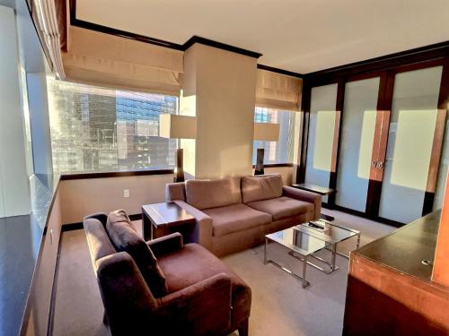 a living room with a couch and chairs and a table at Jet Luxury at The Vdara in Las Vegas