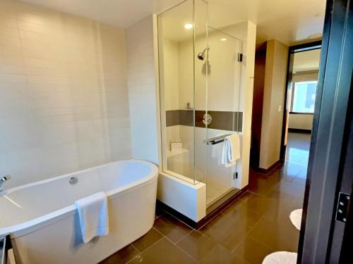 a bathroom with a bath tub and a shower at Jet Luxury at The Vdara in Las Vegas