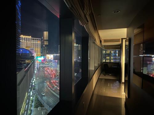 a room with a view of a city at night at Jet Luxury at The Vdara in Las Vegas