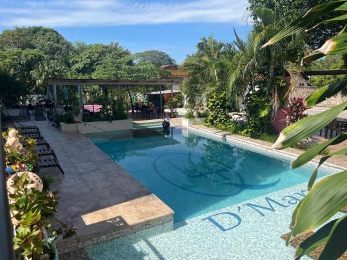 a pool at a resort with a person standing in it at Hotel D Marco Exxpres in Palenque