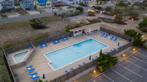 an overhead view of a swimming pool with lounge chairs at Oceanfront 2 Bedroom Condo at Golden Strand in Kill Devil Hills