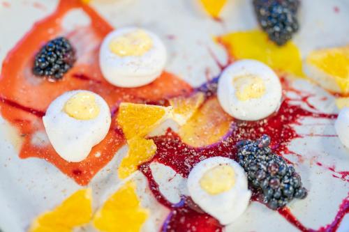 a pizza with eggs and fruit on a plate at The Lodge at Bow Lake in Lake Louise