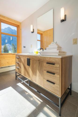 a bathroom with a wooden dresser with a mirror at The Lodge at Bow Lake in Lake Louise
