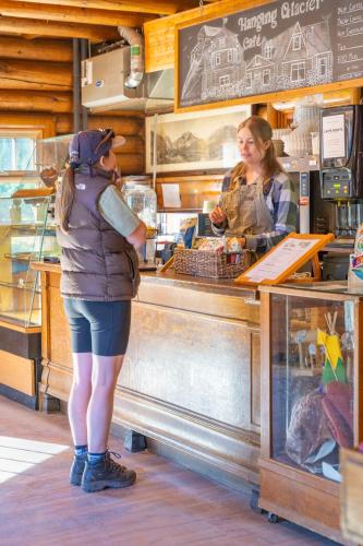 a woman standing at the counter of a food truck at The Lodge at Bow Lake in Lake Louise