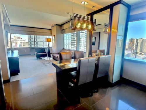a dining room with a view of a living room at Jet Luxury at The Vdara in Las Vegas