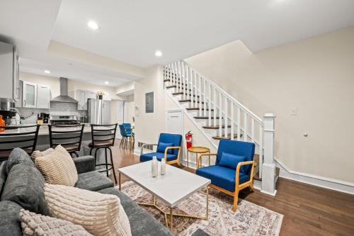 a living room with a couch and chairs and a kitchen at Spacious 3-Bedroom Apt in the Heart of Philly in Philadelphia