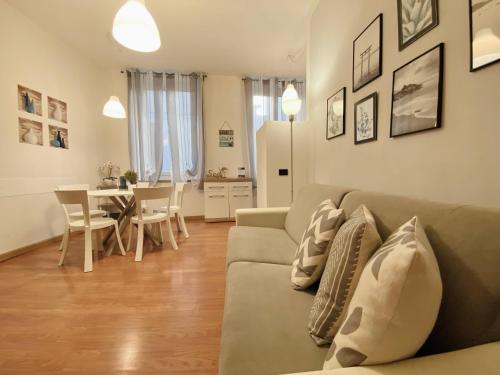 a living room with a couch and a dining room at Mazzini 12, Elegant Central Apartment, Air Conditioning, Wi-Fi, Just 100 mt from the Public Beach, the Ideal Choice for a Relaxing and Exciting Coastal Escape, private garage available on request at 20,00 per night in Rapallo