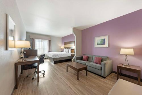 a hotel room with a bed and a couch at Best Western Plus Buda Austin Inn & Suites in Buda