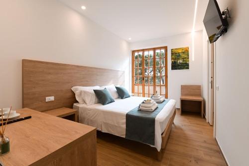 a bedroom with a bed and a television in it at Villa Lucilla - B&B Rooms and Pool in Potenza Picena