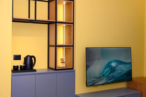 a flat screen tv sitting on a wall at Adore Home in Tirana