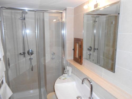 a bathroom with a shower and a toilet and a sink at Lo Spedalicchio in Bastia Umbra
