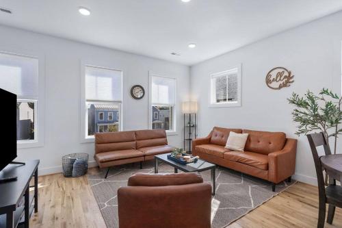 a living room with a couch and a table at Duplex with Balcony and Spacious Dog-Friendly Oasis! in Richmond