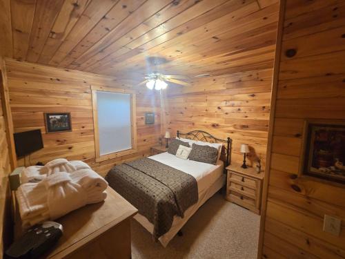 a bedroom with a bed in a wooden cabin at A Wispful Dream in McHenry