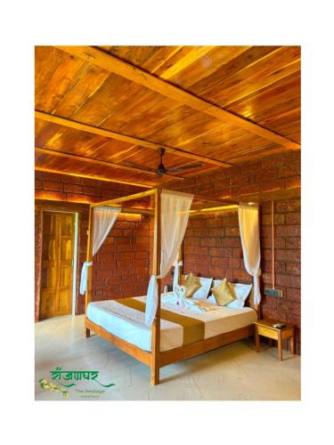 a bed in a room with a wooden ceiling at Ranjanghar in Gimvi