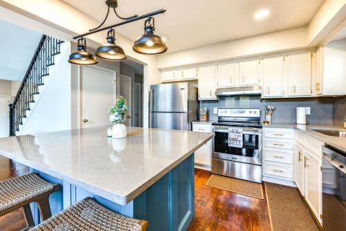 a large kitchen with white cabinets and a large island at Dock and Hot Tub at High Rock Lake Retreat in Lexington