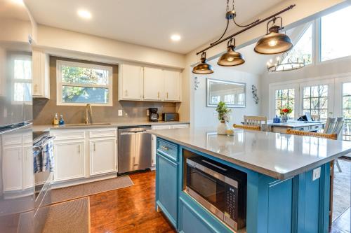 a kitchen with blue cabinets and a large island at Dock and Hot Tub at High Rock Lake Retreat in Lexington