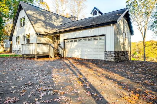 a white house with a garage and a driveway at Dock and Hot Tub at High Rock Lake Retreat in Lexington