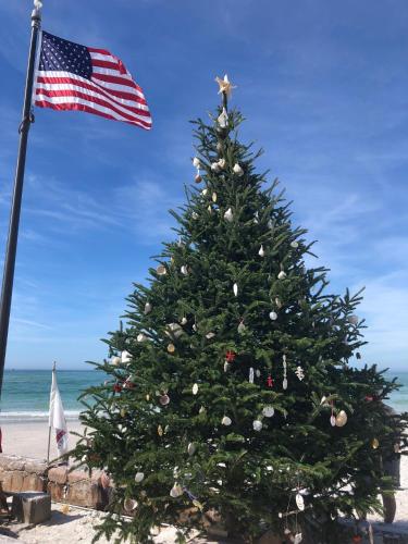 a christmas tree on the beach with an american flag at Sarasota -Walk to Siesta Key Beach in Sarasota