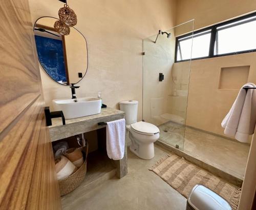 a bathroom with a sink and a toilet and a shower at Chichén 27 Departamentos nuevos con piscina cerca de Ferry a Isla Mujeres in Cancún