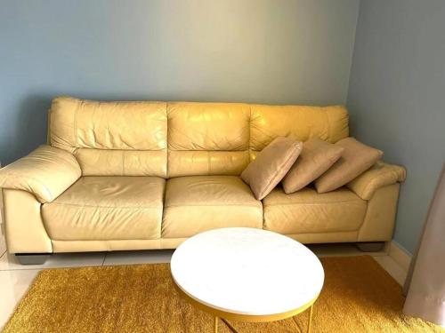 a living room with a couch and a white table at Blue Aesthetic Luxury Seaview 3 min Drive Sunway in Butterworth