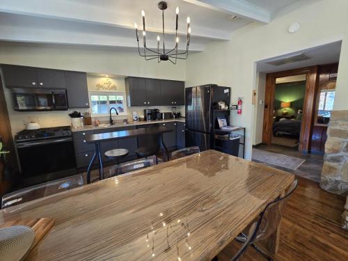 a kitchen with a wooden table and a dining room at Slips and Slopes in McHenry