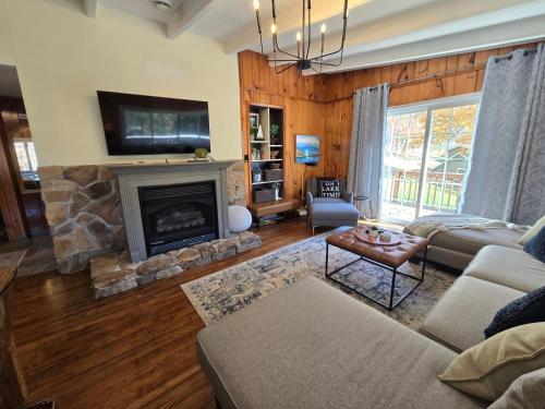 a living room with a fireplace and a couch at Slips and Slopes in McHenry
