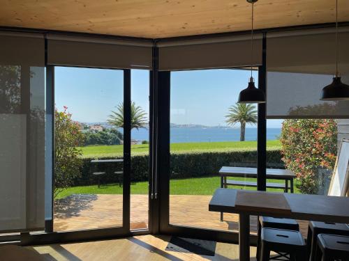 a view of the ocean from the porch of a house at Cabañas de Canide in A Coruña