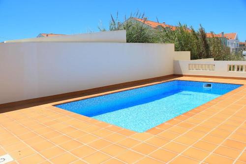 a swimming pool on the side of a house at Baleal Beach Apartment in Baleal