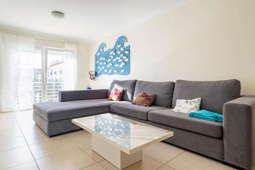 a living room with a couch and a coffee table at Baleal Beach Apartment in Baleal