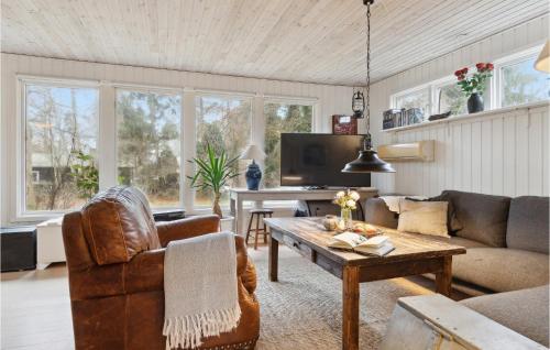 a living room with a couch and a table at 2 Bedroom Beautiful Home In Orø in Orø