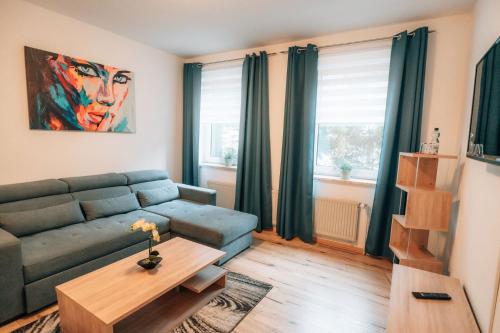 a living room with a couch and a table at Zellerfelder Hof in Clausthal-Zellerfeld