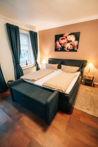 a bedroom with a large bed in a room at Zellerfelder Hof in Clausthal-Zellerfeld