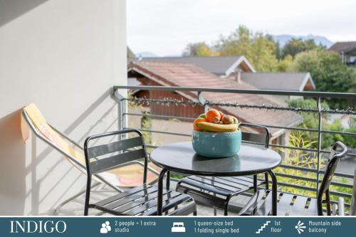 a bowl of fruit sitting on a table on a balcony at Cote Ouest in Sévrier