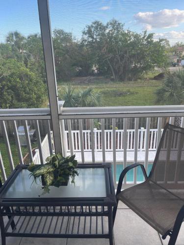 a table and chairs on a balcony with a view at Sarasota -Walk to Siesta Key Beach in Sarasota