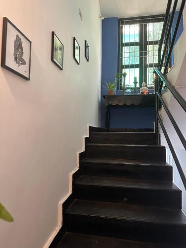 a staircase in a house with blue walls at SOLS Backyard in Arambol