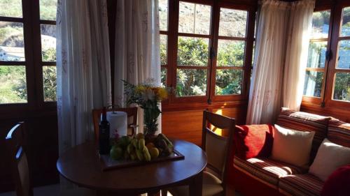 a living room with a table with fruit on it at El Junquillo by Villas Rivero in Santa Maria de Guia de Gran Canaria