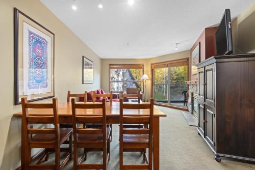 a dining room with a wooden table and chairs at The Aspens by Whistler Premier in Whistler