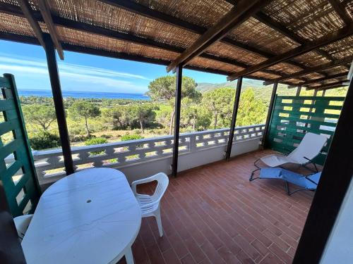 a balcony with a table and chairs and the ocean at Villa Conti Residence in Lacona