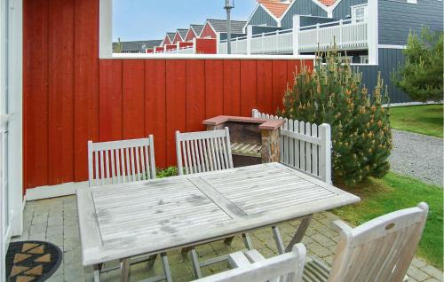 a wooden table and chairs with a table and a tableasteryasteryasteryasteryastery at Holiday Home Vandflodvej Blåvand I in Blåvand