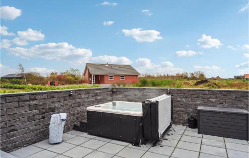 a hot tub on top of a brick wall at Gorgeous Home In Tarm With Kitchen in Tarm