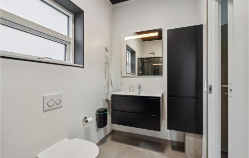 a bathroom with a sink and a mirror at Gorgeous Home In Tarm With Kitchen in Tarm