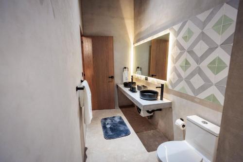 a bathroom with a white toilet and a sink at Casa 1800 Oaxaca Boutique Hotel City Center based in Oaxaca City