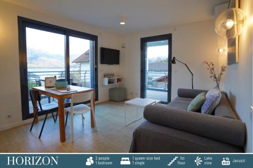 a living room with a couch and a table at Cote Ouest in Sévrier