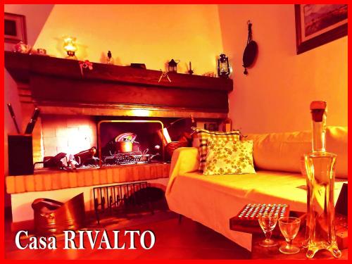 a living room with a couch and a fireplace at Casa RIVALTO - Antiche Dimore Pisane in Rivalto