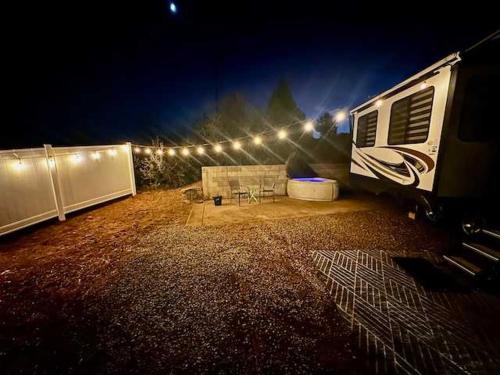 an rv parked in a yard at night at Puffy Panda RV-Hot Tub-Sleeps 2 in Ahwahnee
