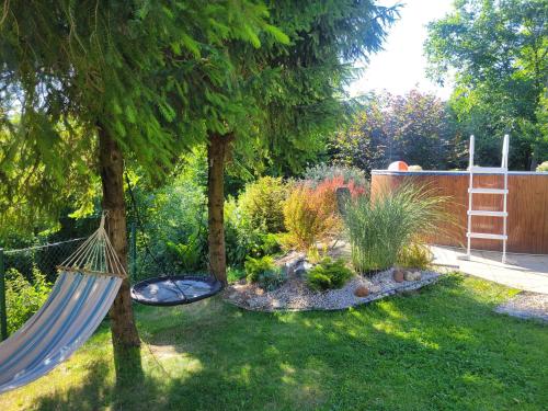 a backyard with a hammock in a garden at Chatka Beskidzka in Targanice